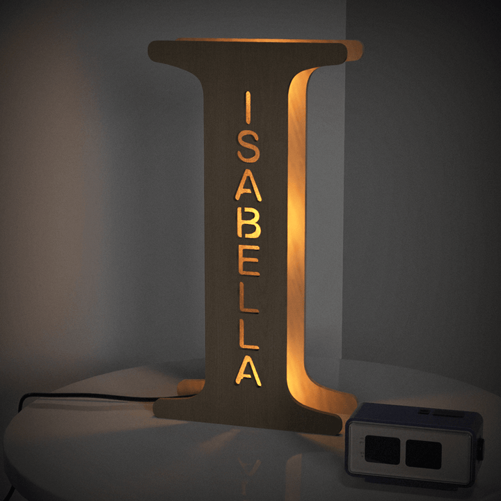 Enchanted Woodland Alphabet Lamp with the letter I and the name Isabella illuminated on a table.